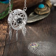 [Design Meaning]:Dream catcher originated in the 18th century. Indians used it to capture beautiful dreams and let nightmares disappear with the morning sun. They believe that the night air is full of dreams, and only dream catchers can filter dreams. Bring them into a beautiful dreamland. [Delicate Design]:This beautiful dream catcher necklace is made of pure metal with a unique micro-carving shape in the middle. It is matched with 3 micro-carved metal hollow blades, and the overall craftsmansh Photo Projection Necklace, Beautiful Dream Catchers, Projection Necklace, Necklace Length Guide, Dream Catcher Necklace, Photo Necklace, Necklace Chain Lengths, Beautiful Dream, Delicate Design