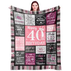 a woman holding up a birthday blanket with the number forty and twenty years on it