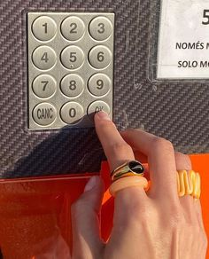 a person's hand is pressing the button on a parking meter with their finger