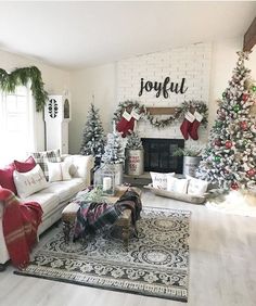 a living room decorated for christmas with white furniture