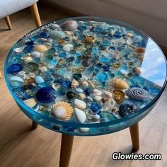 a glass table topped with lots of sea shells