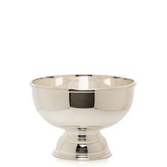 a silver bowl sitting on top of a white table