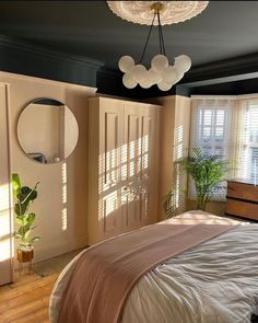 a bed sitting in a bedroom next to a window