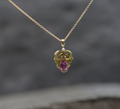 "This Art Nouveau pendant shows the feminine curves we love from this period with bright lime green enamel work and a lovely pink sapphire as the center piece. This is a conversion necklace repurposed from a stickpin. The chain is sold separately. Gemstones: Pink Sapphire Weight: 1=0.58 cts estimated Measurements: 6.2 x 4 x 2.9 mm Cut: Oval Faceted Color: Bright Hot Pink Clarity: eye clean Gemstones: Natural Seed Pearl Measurements: 1.8 mm Shape: Round Color: white Chain available upon request a Elegant Hallmarked Pink Sapphire Jewelry, Exquisite Pink Pendant Necklace, Exquisite Pink Sapphire Jewelry Gift, Exquisite Pink Sapphire Jewelry For Gift, Elegant Pink Sapphire Necklace For Formal Occasions, Fine Jewelry Hallmarked Pink Sapphire, Fine Jewelry Pink Sapphire With Hallmark, Pink Sapphire Pendant Jewelry As Gift, Elegant Yellow Gold Necklaces With Pink Sapphire