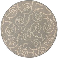 a round rug with an intricate design on the bottom and sides, in grey and white