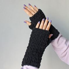 "Texting Gloves These chunky knit fingerless mittens; Made with chunky 100% hypoallergenic micro-polyester yarn, vegan friendly. The knitted wrist warmers are incredibly soft, fluffy and so nice to touch. These seamless knit fingerless gloves allow you to use your fingers freely while keeping your hands warm. You can use your phone, keyboard or hold your coffee mug comfortably. Match with infinity scarf of the same color: https://etsy.me/3r6mSRt Measuring approximately 7.8\" / 20 cm long, one size fits most.  Please note the sizes may differ very slightly due to the handmade nature of the item. This hand knitted winter accessory is a warm and stylish gift for women. * Machine washable at 30 degrees * Dry flat * Dry cleanable * Do not iron Your knit hand warmers will be packed with tissue p Cozy Black Knitting Pattern For Winter, Cozy Black Winter Knitting Pattern, Cozy Black Hand Knitted Pattern, Cozy Black Knitting Pattern, Black Yarn Knitting Pattern, Winter Hand Knitted Black Knitting Pattern, Black Hand Knitted Knitting Pattern, Winter Black Knitting Pattern, Black Hand Knitted Pattern