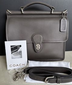 Coach classic willis bag  gray leather    turnlock closure - large open compartment - unlined leather - zip pocket 2 slip pockets, one under flap, one located outside rear silver tone nickel hardware removable / adjustable brass buckle strap 22.5" drop top handle for satchel 10.5"h x 10.5"w x 2-3.5"d approx. dimensions coach embossed hangtag   condition- new old stock, unused, comes with booklet and dust bag  - beautiful! rare! made in costa rica - 1999 - beautiful!  photo's don't do this bag justice, so much more beautiful in person. getting hard to find!    thank you so much for looking and have a wonderful day! Coach Metropolitan Soft Pack, Classic Flap Shoulder Bag With Palladium Hardware, Classic Formal Satchel With Gunmetal Hardware, Classic Satchel With Silver-tone Hardware And Flap, Classic Business Shoulder Bag With Gunmetal Hardware, Classic Formal Bag With Gunmetal Hardware, Classic Gray Top Handle Bag, Classic Formal Shoulder Bag With Gunmetal Hardware, Classic Gray Rectangular Bag