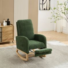 a green rocking chair sitting on top of a white rug