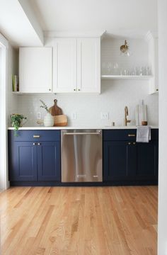 a kitchen with blue cabinets and wooden floors