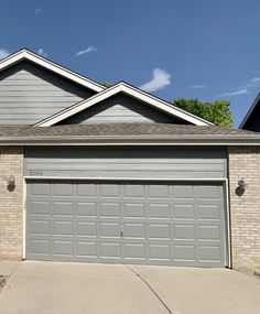 a house with two garage doors on the side of it