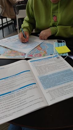 a person sitting at a table with some papers