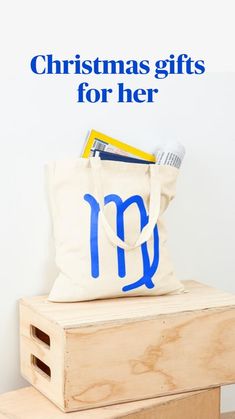 a tote bag sitting on top of a wooden box next to a stack of books