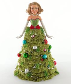 a green christmas tree ornament with a blonde woman in a dress and red bow