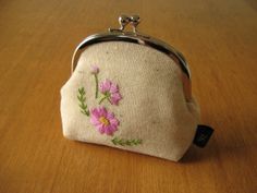 a small purse sitting on top of a wooden table