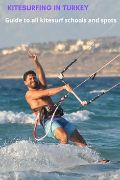 a man kite surfing in the ocean with his hands up and holding on to ropes