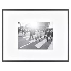 black and white photograph of people crossing the street