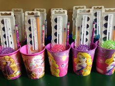 there are many pencils in cups with princesses on them, and one is empty