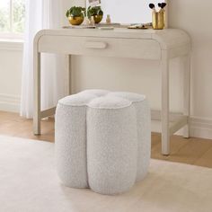 a white table with two stools and a mirror