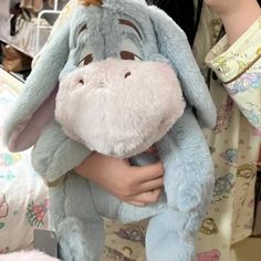 a person holding a stuffed animal in their hands