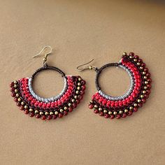 Macrame Boho Earrings Add a pop of boho style to your outfit with these stunning macrame boho earrings! The intricate knotting technique creates a unique and eye-catching design that is sure to turn heads. Featuring beautiful red, grey, brown and bronze colors, these earrings will complement any look. Handcrafted with care, these earrings are comfortable to wear all day long. Upgrade your accessory game with these must-have macrame earrings.  Made of macrame and high quality brass. A pair of ear Bohemian Adjustable Macrame Tassel Earrings, Bohemian Adjustable Beaded Earrings, Fair Trade, Bohemian Fair Trade Adjustable Beaded Earrings, Traditional Macrame Earrings, Fair Trade Red Jewelry For Festivals, Red Fair Trade Jewelry For Festivals, Festival Macrame Dangle Jewelry, Bohemian Macrame Tassel Dangle Earrings, Bohemian Macrame Tassel Earrings