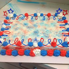 a cake with red, white and blue frosting on it sitting on top of a table