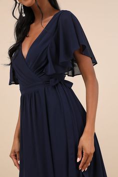 Stroll effortlessly into the venue, knowing you look stunning in the Lulus Convincing Grace Navy Blue Flutter Sleeve Wrap Maxi Dress! Lightweight woven chiffon shapes short flutter sleeves that frame a surplice bodice with subtle pleating and a low V-back. Internal ties thread through the banded waist, securing the wrap silhouette. Skirt has a flaring, overlapping design that falls to a maxi hem. Fit: This garment fits true to size. Length: Floor length. Size medium measures 60.5" from shoulder Blue V-neck Wrap Dress With Ruffles, Flowy Blue Wrap Dress With Surplice Neckline, Party V-neck Chiffon Wrap Dress, Evening Wrap Dress With Ruffles And Surplice Neckline, Elegant V-neck Chiffon Wrap Dress, Flowy Wrap Dress With Surplice Neckline For Evening, Formal Flowy V-neck Wrap Dress, Elegant Chiffon Wrap Dress For Party, Elegant Chiffon Wrap Dress