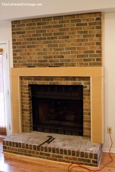 a brick fireplace in the middle of a living room