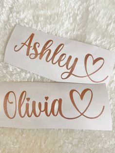 two stickers with the words ashley and livia written in copper foil on them