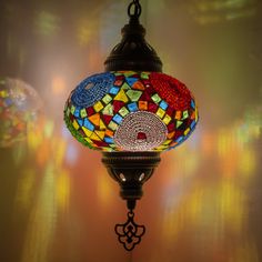 a multicolored glass lamp hanging from a ceiling