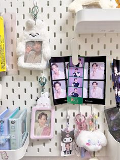 the wall is covered with pictures and other items, including keychain clips to hang them on