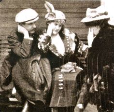 an old black and white photo of two people dressed in costume talking to each other