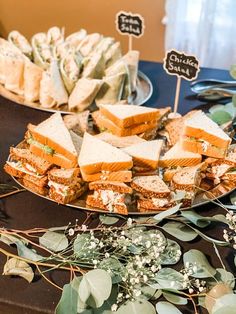 a table topped with plates filled with sandwiches