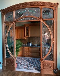 an ornately designed kitchen with wood cabinets and glass doors