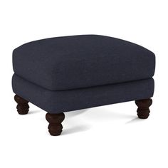 the footstool is made out of wood and has a dark blue upholstered fabric