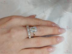 a woman's hand with two rings on it and one ring is in the shape of a baguette