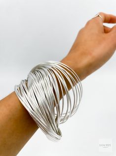 Silver Slinky Bangle Bracelets, Slinky Silver Bangle Bracelets, Silver Flexible Round Bangle, Slinky Bangle Jewelry As A Gift, Modern Silver Flexible Bangle, Heavy Silver Bangle, Silver Adjustable Flexible Bangle, Adjustable Flexible Silver Bangle, Big Bangles