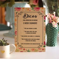 a menu sitting on top of a table next to a potted plant