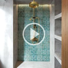 a shower head and hand held shower faucet in a bathroom with blue tile