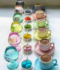 there are many different cups and saucers on the table