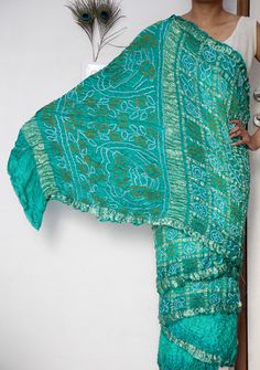 Discover the timeless elegance of our Gaji Silk Saree, a true masterpiece of traditional craftsmanship. Handcrafted from luxurious Gaji silk, this saree offers a lustrous sheen and a smooth, soft texture that drapes beautifully. The intricate patterns and vibrant colours are the result of meticulous hand-dyeing techniques, making each saree a unique piece of art. Perfect for special occasions, weddings, or festive celebrations, our Gaji Silk Saree combines heritage and sophistication.  ➢ Manufac Bollywood Style Green Pre-draped Saree With Motifs, Green Pre-draped Saree With Zari Weaving For Transitional Season, Transitional Green Raw Silk Saree, Transitional Green Pre-draped Saree With Zari Weaving, Transitional Season Green Raw Silk Saree, Green Fitted Bohemian Pre-draped Saree, Green Traditional Wear For Transitional Season, Traditional Green Pre-draped Saree For Transitional Season, Festive Turquoise Silk Traditional Wear