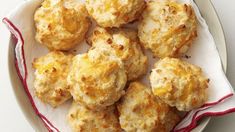 some biscuits are sitting on a plate with a red and white stripe around it, ready to be eaten