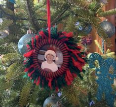 a christmas ornament hanging from the top of a tree