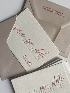 three envelopes with red calligraphy on them, one has a date and the other is