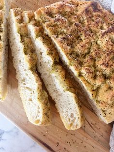 slices of bread sitting on top of a wooden cutting board