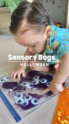 a little boy playing with some halloween decorations