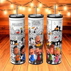 three cartoon tumblers sitting on top of a wooden floor