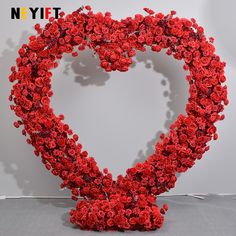 a heart shaped sculpture made out of red flowers