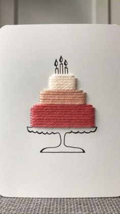 a piece of cake with candles on it is sitting on top of a white card