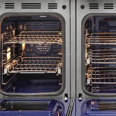 two double ovens with the doors open and one is empty, both are blue