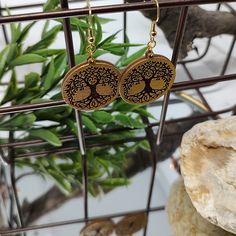 Make a statement with these Gold Tree of Life Wooden Earrings! Featuring a detailed Tree of Life design, these lightweight wooden earrings with a gold coating will make you stand out from the crowd. The round shape creates an elegant and timeless look that’s perfect to spruce up any outfit! Length: 2 Inches Weight: 1 oz Material: Wood Earring Finding Type - French Hook Style Silver or Gold Hooks Nickel-free Super lightweight Hand-Painted Earrings Include Rubber Backing Hand Painted Earrings, Gold Tree, Wooden Earrings, Life Design, Wood Earrings, Earring Findings, Tree Of Life, 18k Gold, Gold Plate